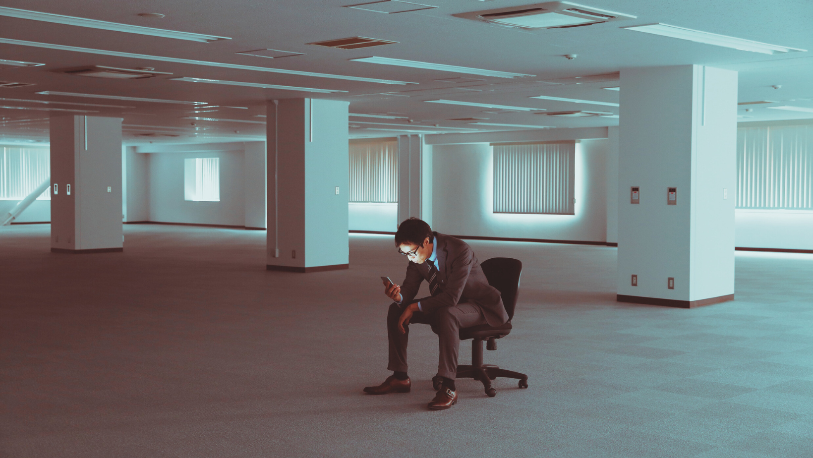 man sitting in empty office floor